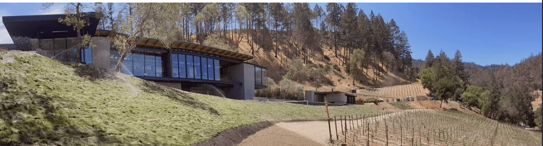 Modern vineyard building with hillside landscape