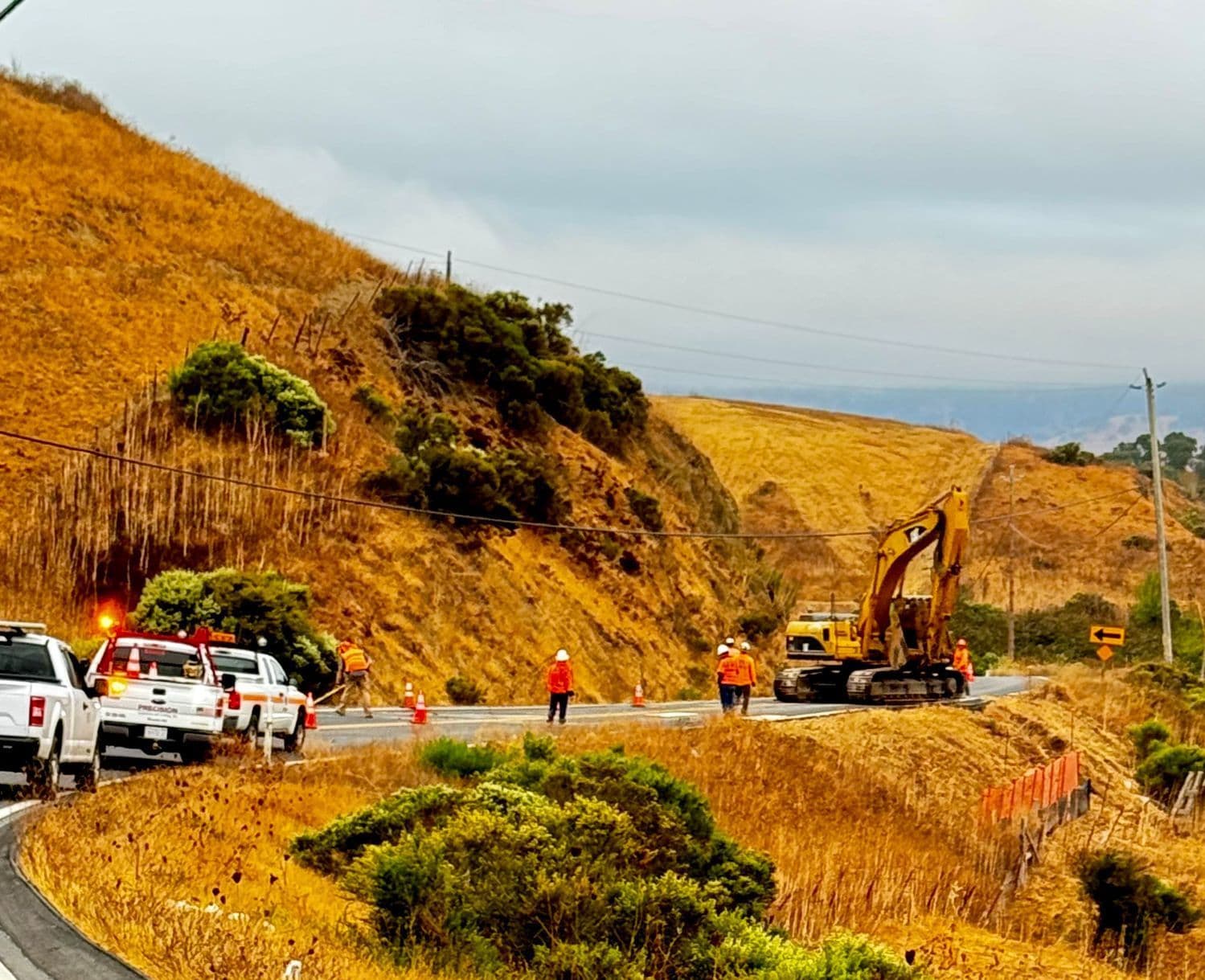 Excavator working on highway shoulder