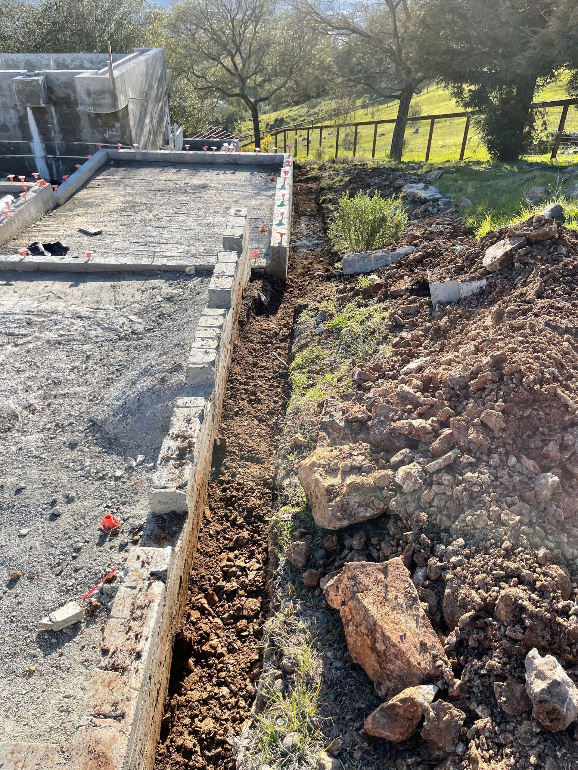Excavator digging utility trench